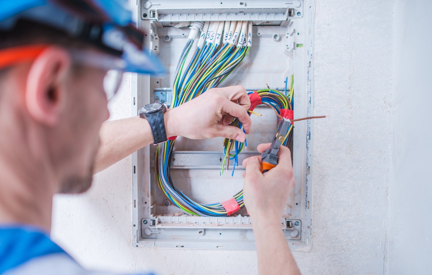 Caucasian electric technician installing wires