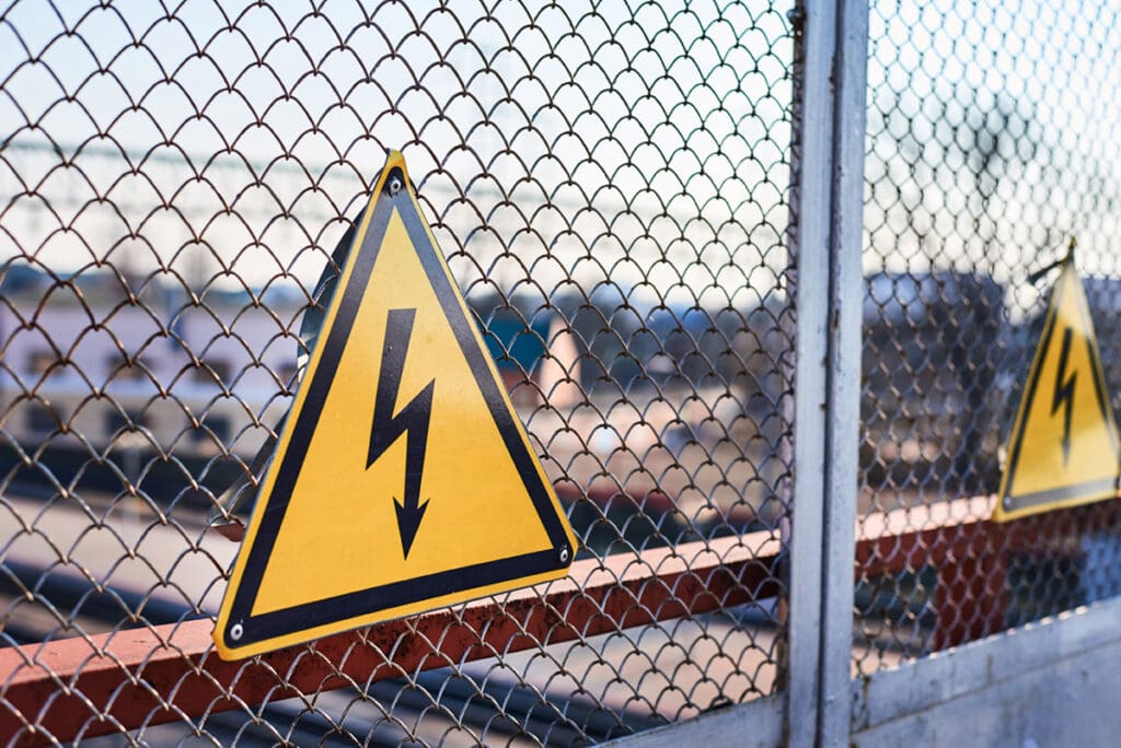 Electrical hazard sign. High voltage electricity on a railway station