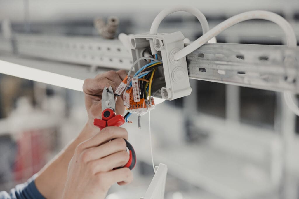 Electrical Expertise in Action, Junction Wiring Installation with Skilled Hands in Close-up view