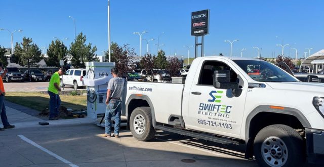 Swiftec workers installing an EV charging station